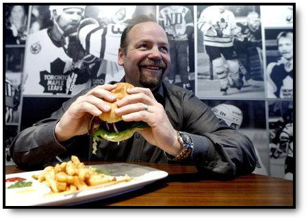 Photo of Wendel enjoying a burger and fries.